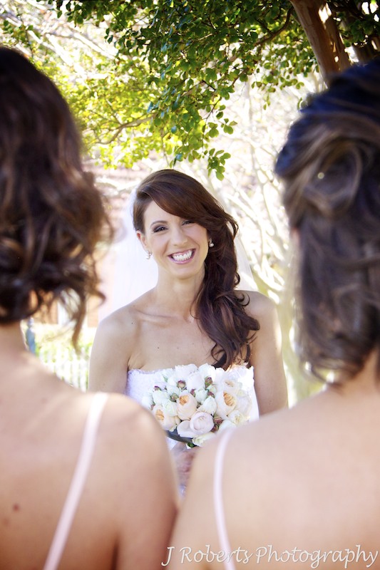 Bride smiling at her bridesmaids - wedding photography sydney